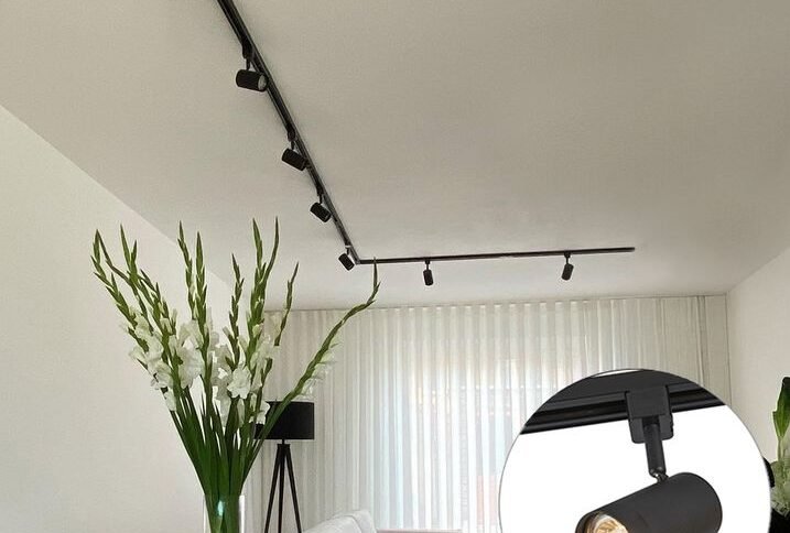 Modern spotlights illuminating living room and kitchen area