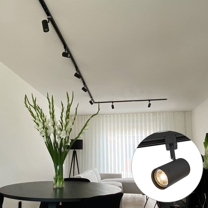 Modern spotlights illuminating living room and kitchen area