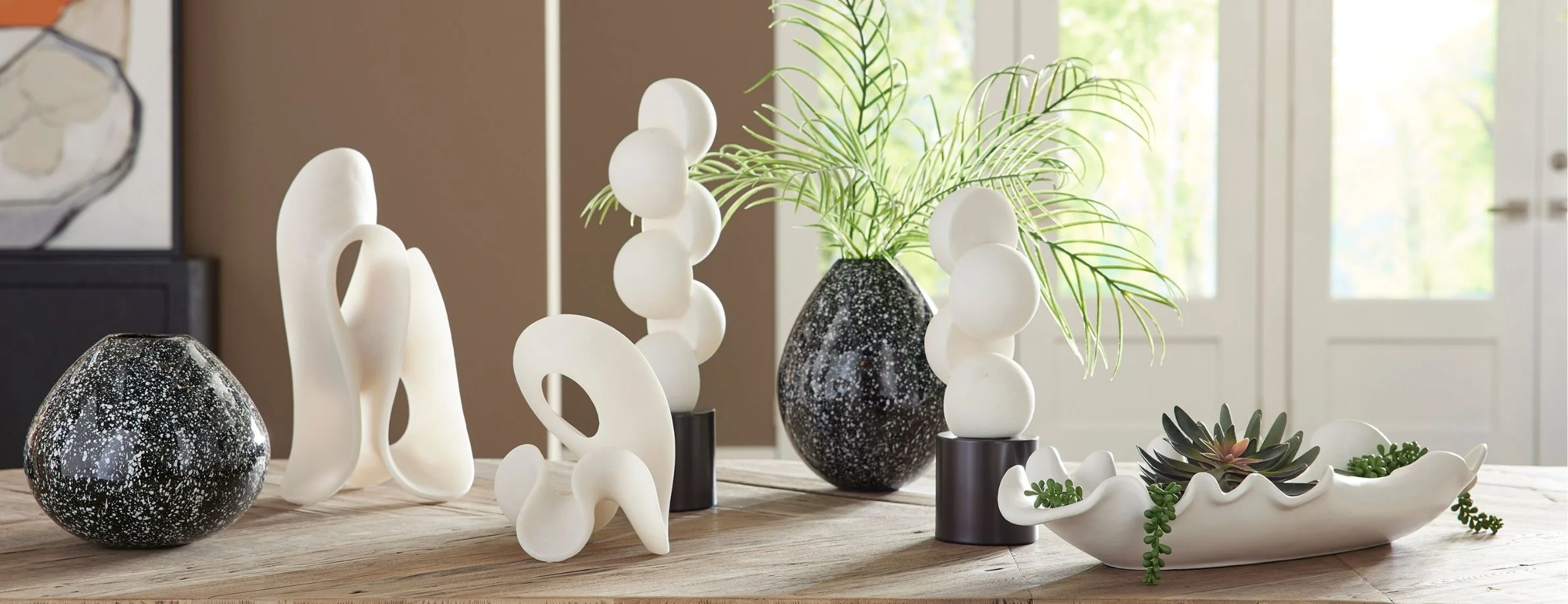 Decorative accessories including art, mirrors, lighting fixtures, plants, and decorative objects for stylish interiors